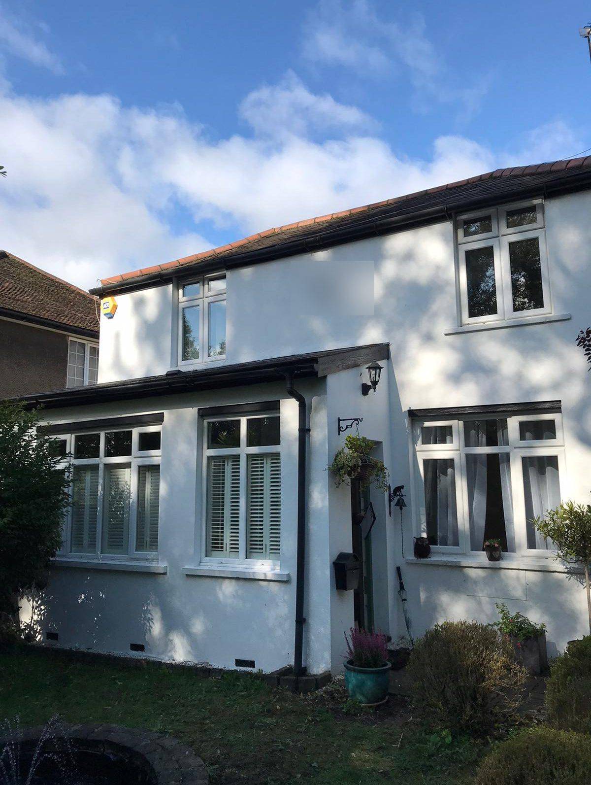 Front of the white-rendered cottage, where the glazed entrance canopy is proposed (Design and Access Statement)