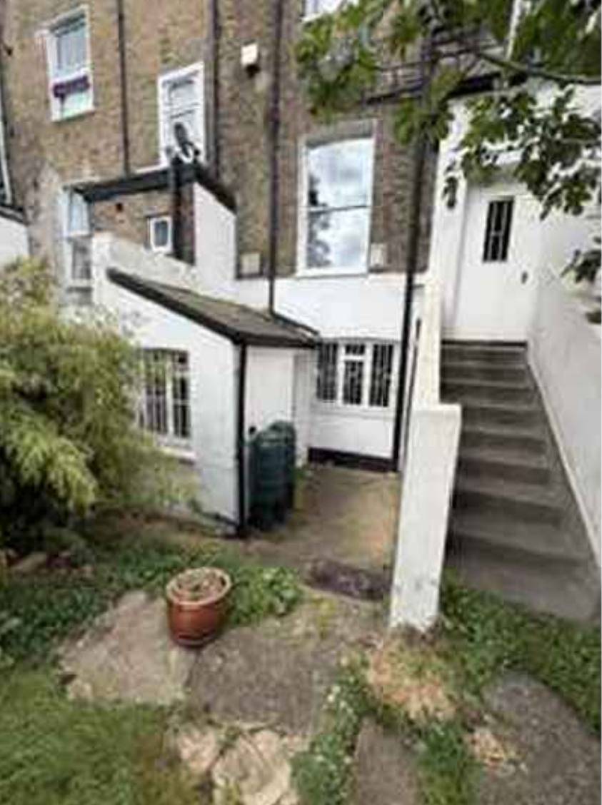 Existing rear elevation and lower-level courtyard (site photographs)