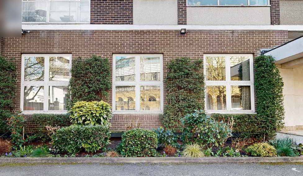Existing white-framed windows on the front elevation of the flat (existing windows photographs)