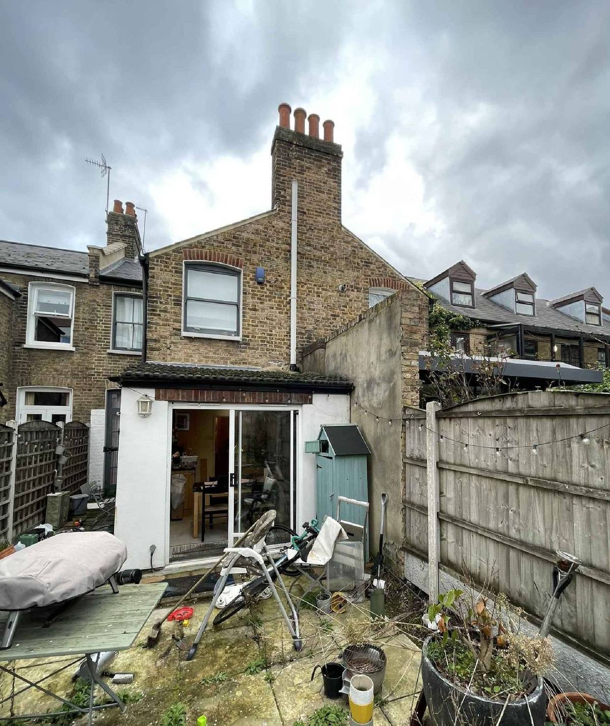 Rear elevation and garden of the existing house before the works (site photo sheet)